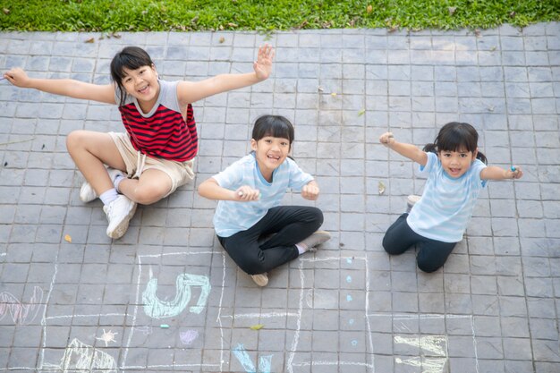 Children playing with colored chalks