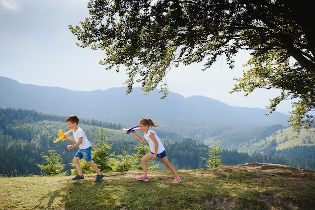 Children playing with toy airplanes