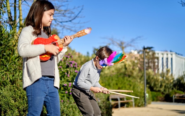 Children playing with toy instruments in the park