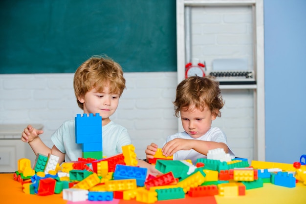 Children playing with toy train. Toddler kids play with blocks. Educational toys for preschool and kindergarten child.