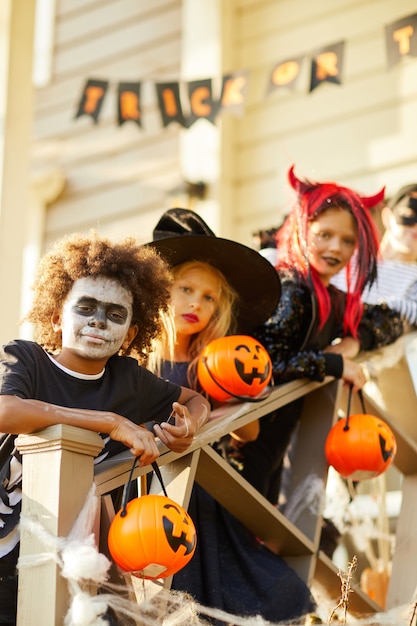 Children Posing Outdoors on Halloween