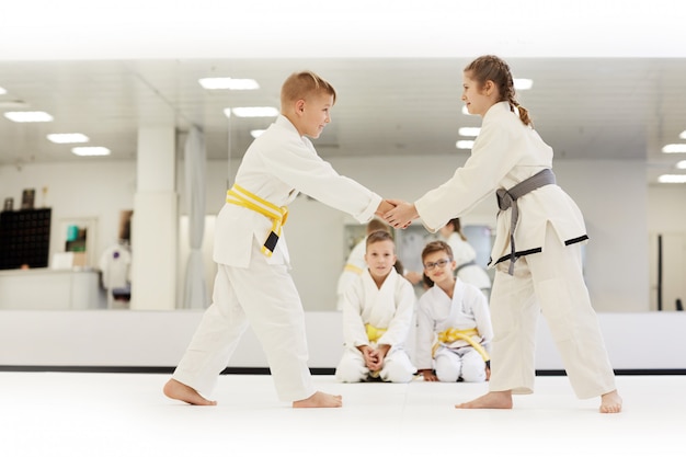 Children practicing karate in gym