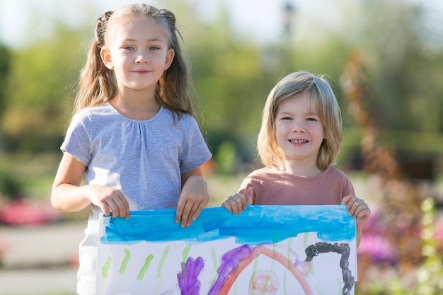 Children proudly show their pictures.