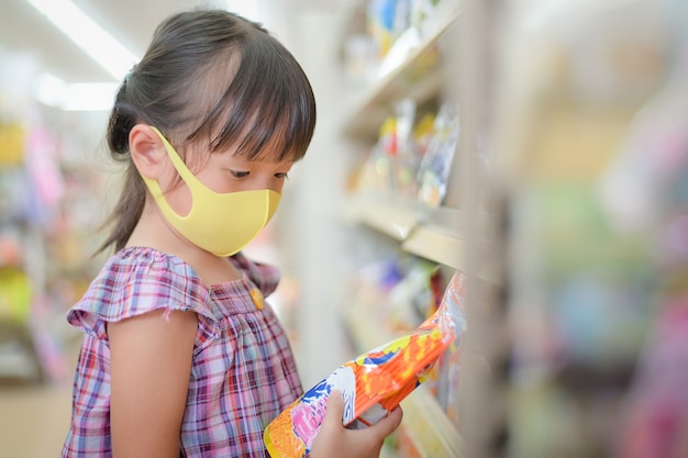 Children read dessert candy labels to see the components and the expiration date