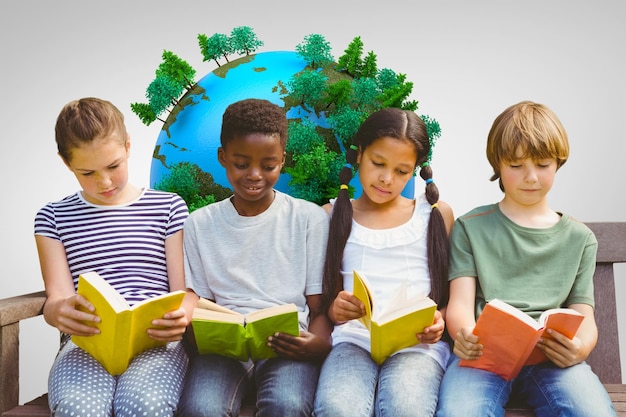 Children reading books at park against grey vignette