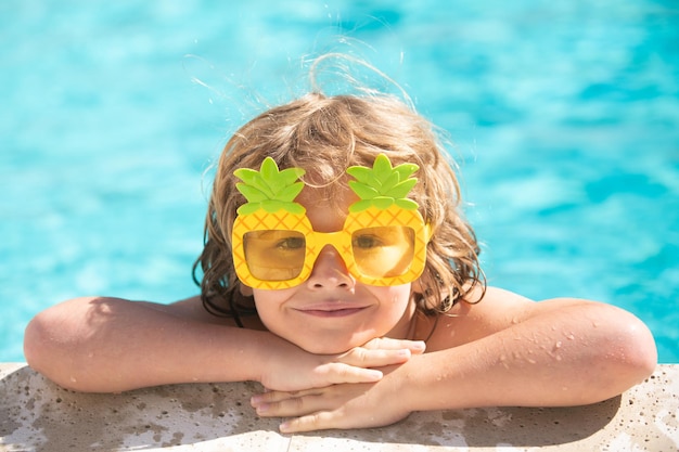 Children relax in the swimming pool. Summer kids activity.