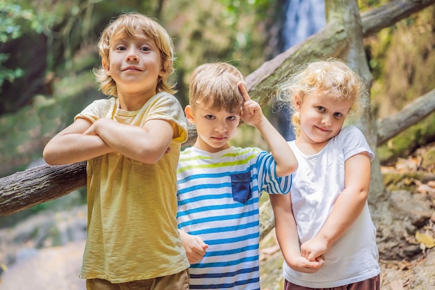 Children rest during a hike in the woods