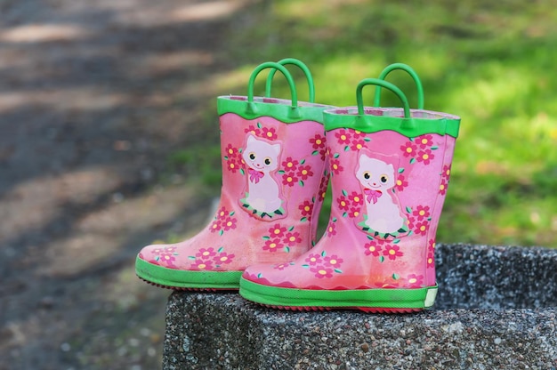 Children rubber boots on the stone