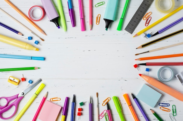 Children's accessories for study, creativity and office supplies on a white wooden background. Back to school concept. Copy space.