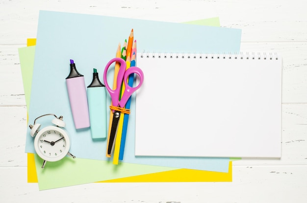 Children's accessories for study creativity and office supplies on a white wooden background Back to school concept Copy space