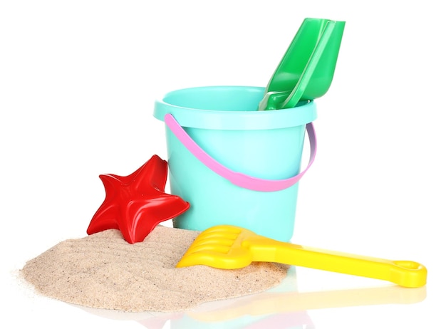 Children's beach toys and sand isolated on white