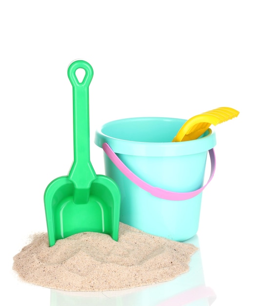 Children's beach toys and sand isolated on white