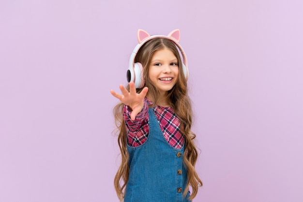 Children's beautiful headphones on a little girl on an isolated background