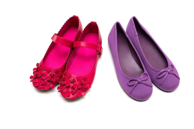 Children's bright purple and pink shoes on a white backgroundxA