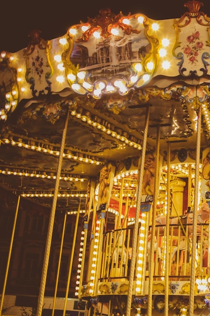 Children's Carousel at an amusement park in the night illumination Vintage photo processing