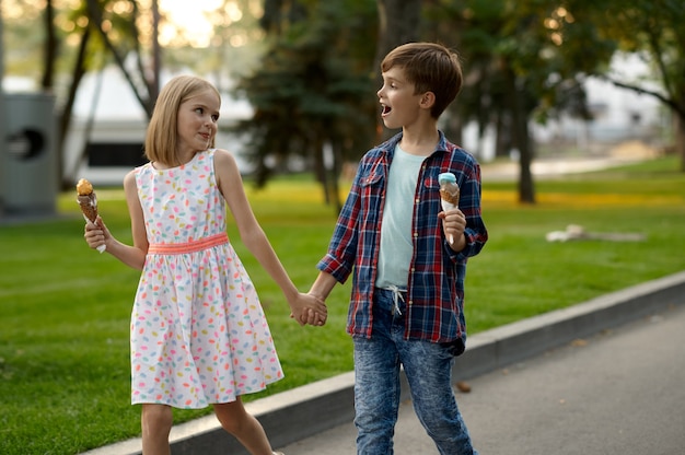 Children's date, boy and girl eating ice cream