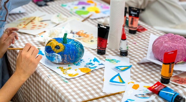 Children's drawing class Pumpkin decoration with paint for children