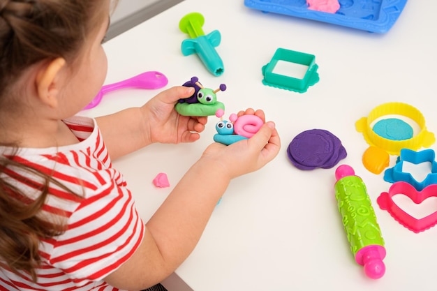 Children's games with plasticine children's hands with plasticine snails creative games playing dough