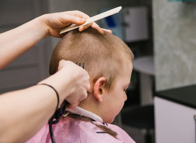 Children's haircut for a boy.Stylish and fashionable hairstyle.Hair care of the child.Short hair.