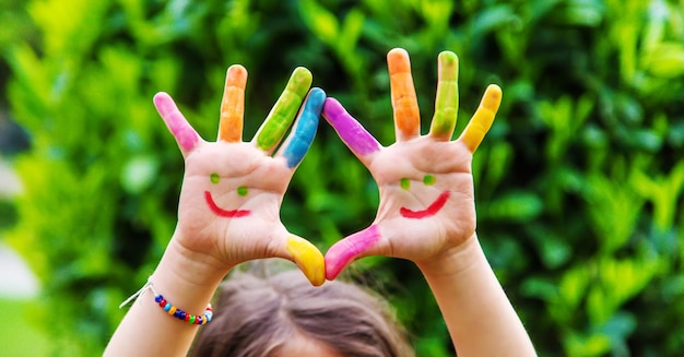 Children's hands in the colors of summer Selective focus