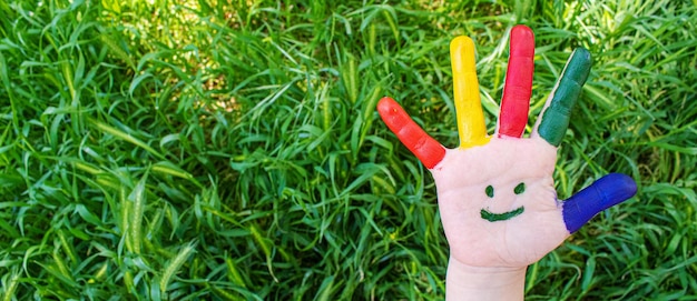 Children's hands in the colors of summer Selective focus