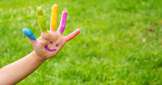 Children's hands in the colors of summer Selective focus