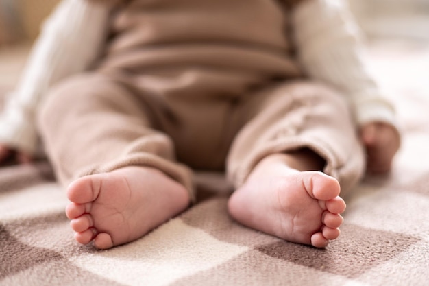 Children's healthy legs closeup children's toes children's heels on the background of the bed in beige shades