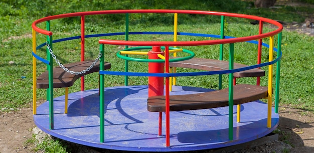 Children's iron carousel. Children's playground. Swing, carousel and slide