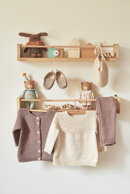 children's knitted clothes on hanger jacket jumper hat shoes toys children's room nursery