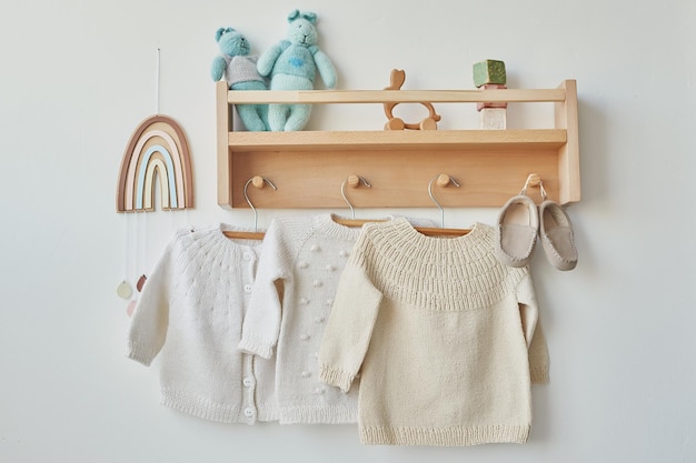 Photo children's knitted clothes shelf with hanger cardigan sweater jumper on hanger children's room nursery