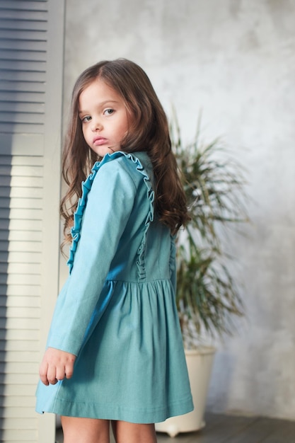 Children's lookbook. Stylish girl in a blue dress