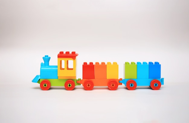 Photo children's plastic constructor a steam locomotive with cubes of rainbow colors