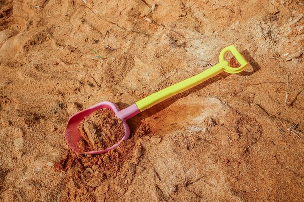 Children's plastic shovel in the sand