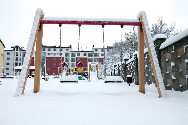 Children's playground covered with snow in winter