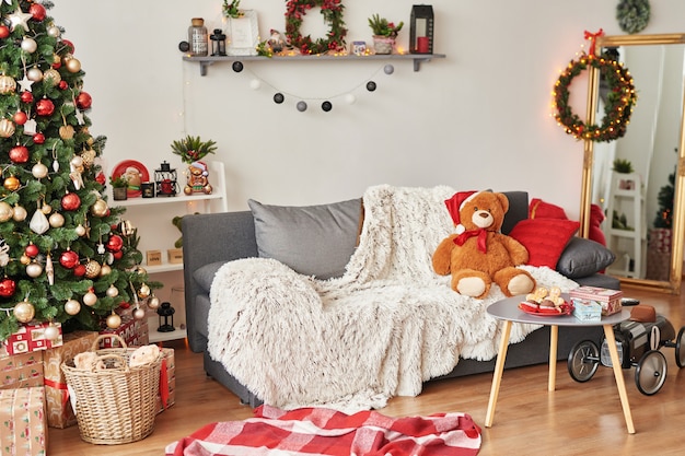 Children's room. Christmas interior of children's bedroom. New Year's decor and tree in children's playroom