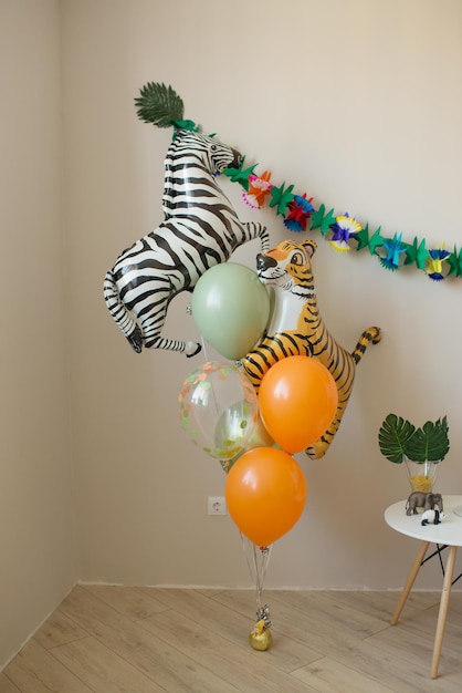 Children's room decorated in honor of the birthday, safari style, animals, cake and balloons