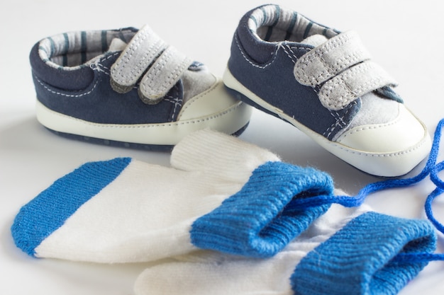 Children's shoes and mittens on a white background