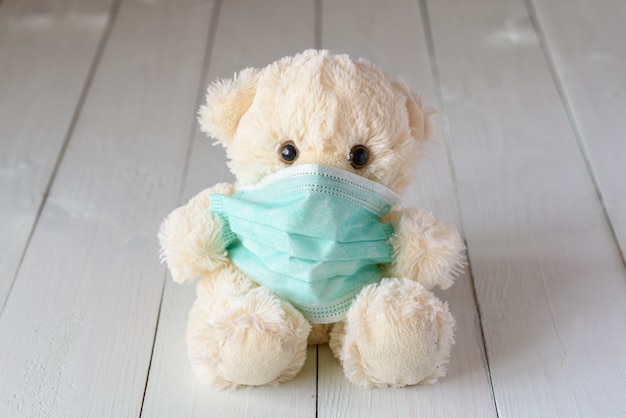 Children's teddy bear in a medical mask