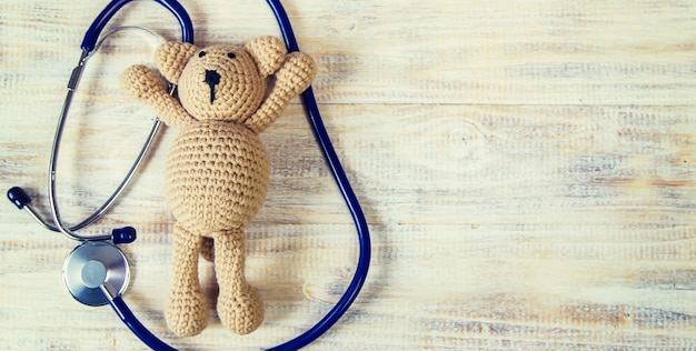 Children's toy and a stethoscope on a light background