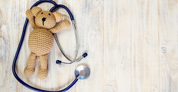 Children's toy and a stethoscope on a light background