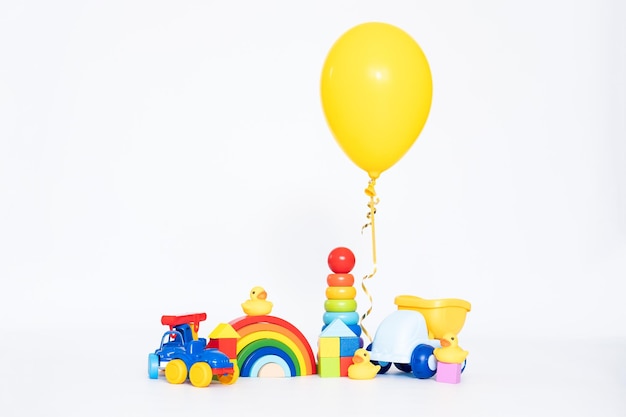 Children\'s toy wooden and colourfull and balloon toy shop\
isolated on white background educational toys