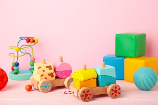 children's toys collection on a pink