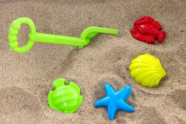 Photo children's toys on sand