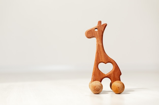 Children's wooden toy horse on a light background, space for text. High quality photo