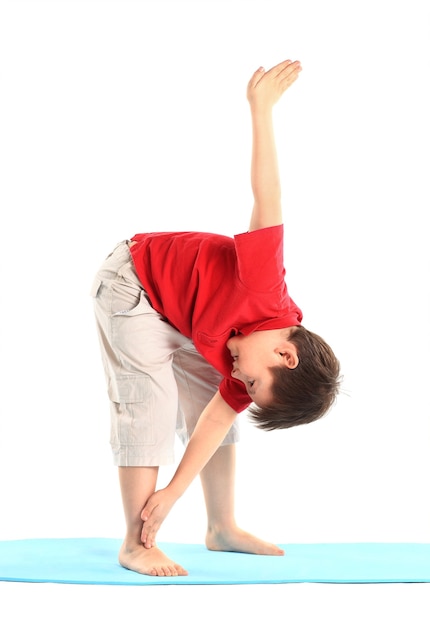 Children's yoga. The little boy does exercise