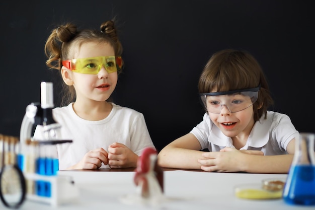 Children scientists Schoolchildren in the laboratory conduct experiments