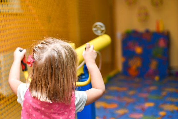 Children shoot at targets with a toy gun