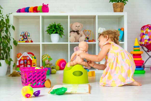 Children sit on the potty in the room Selective focus