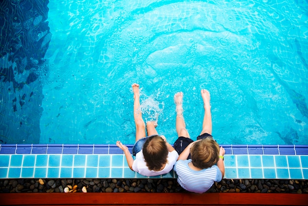 Children sitting by the pool