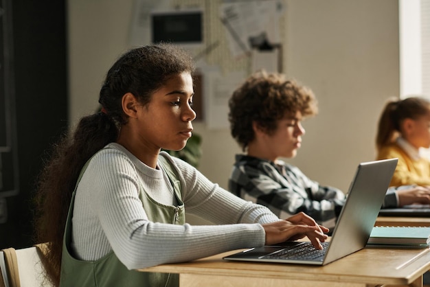 Children sitting at it technology lesson at class